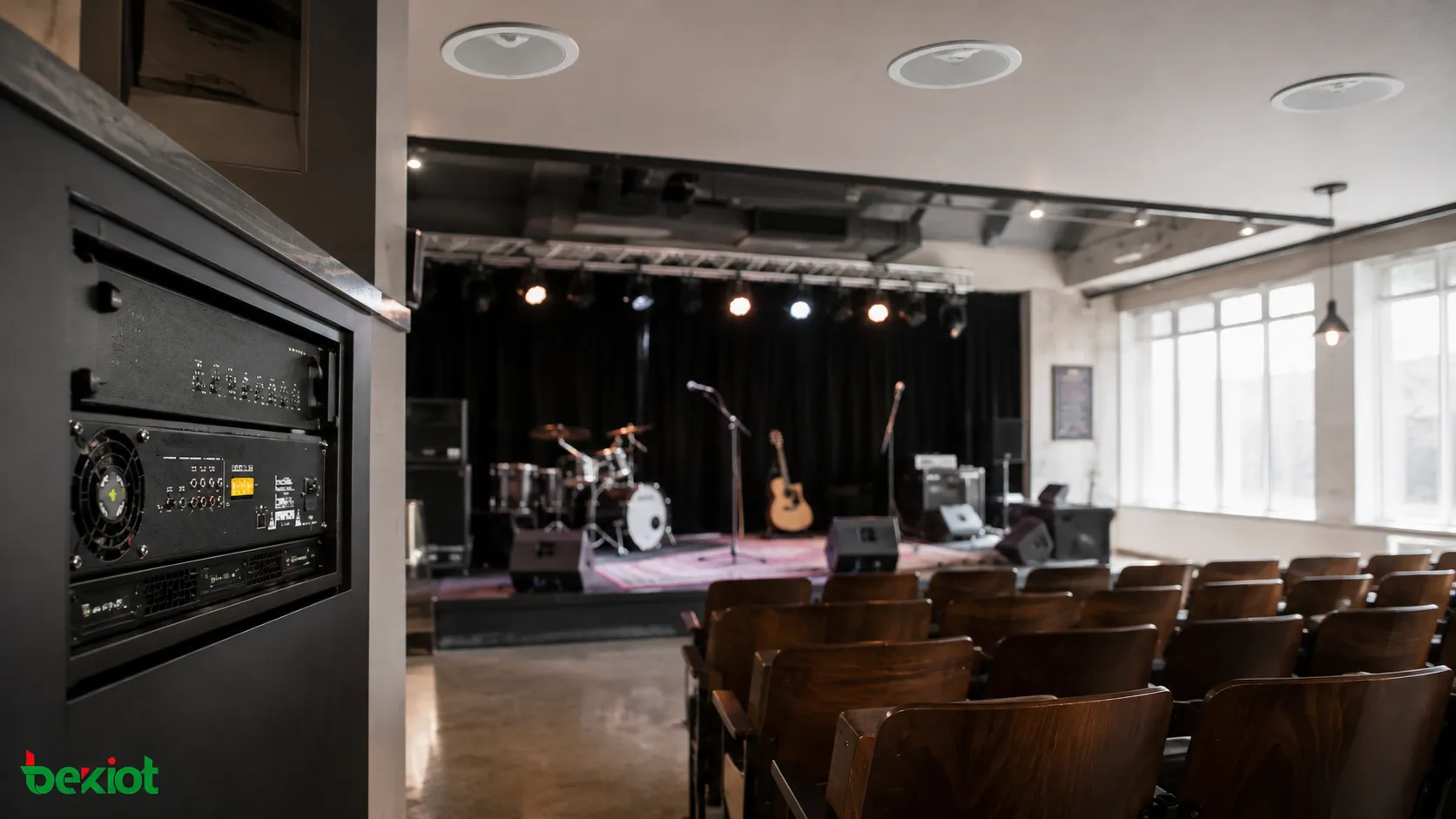 Legacy theater PA system retaining original loudspeakers while upgrading through modern amplifiers, DSP, and network control